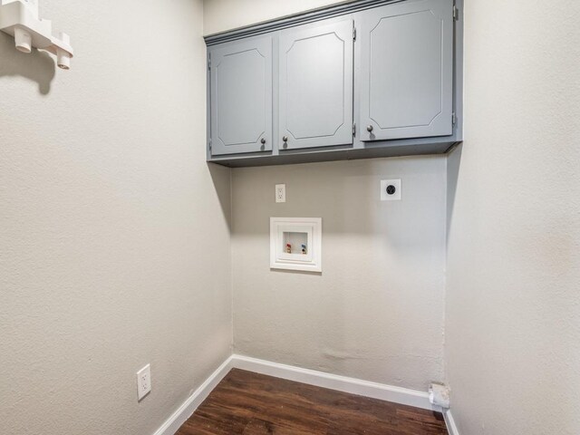 clothes washing area with washer hookup, electric dryer hookup, dark hardwood / wood-style flooring, and cabinets