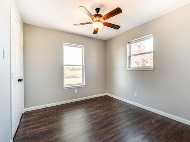 spare room featuring dark hardwood / wood-style floors and ceiling fan