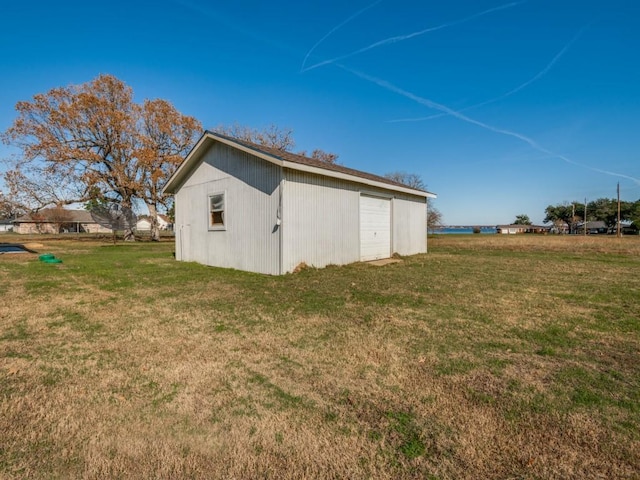 view of outdoor structure with a garage and a yard