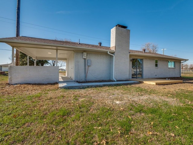 rear view of property with a lawn