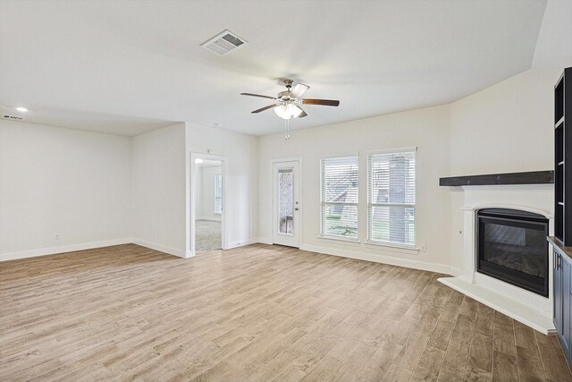 unfurnished living room with ceiling fan and light wood-type flooring