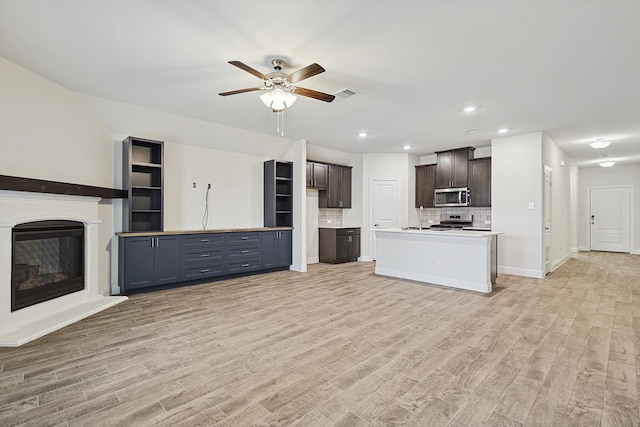 unfurnished living room with light wood-type flooring and ceiling fan