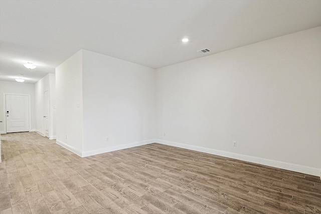 unfurnished room with light hardwood / wood-style floors