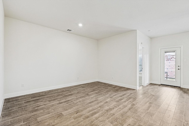 spare room with light hardwood / wood-style flooring