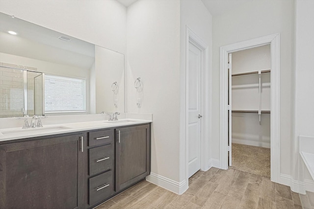 bathroom featuring vanity and an enclosed shower