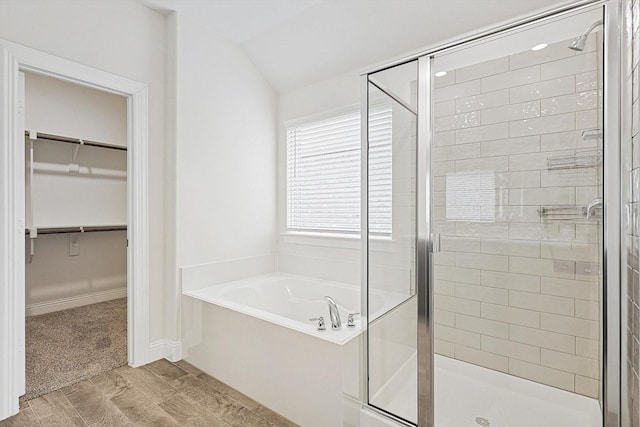 bathroom featuring vaulted ceiling and shower with separate bathtub