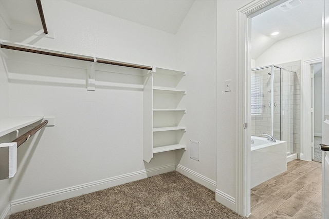 walk in closet with vaulted ceiling