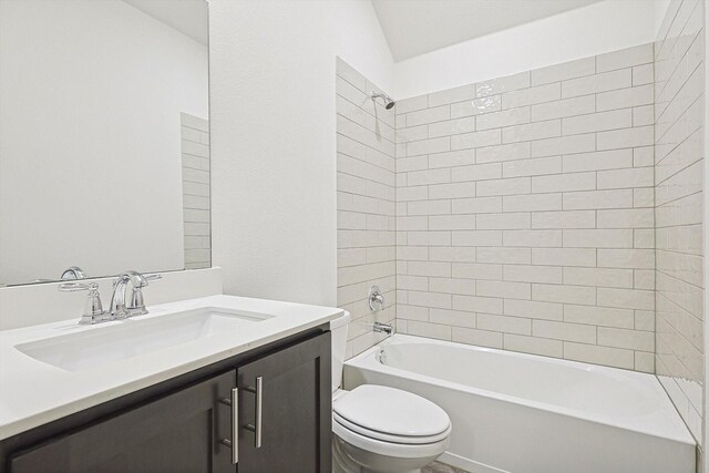 full bathroom with tiled shower / bath combo, toilet, and vanity