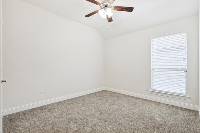 spare room with ceiling fan, carpet floors, and vaulted ceiling