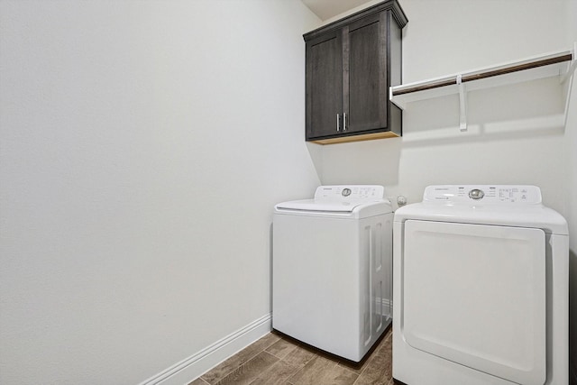 laundry room with cabinets and washing machine and dryer