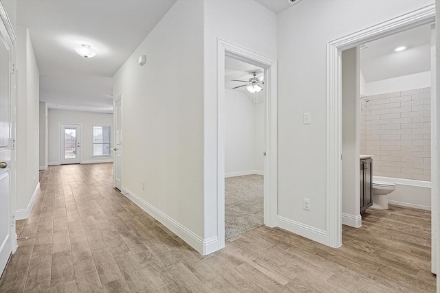 hallway with light hardwood / wood-style floors