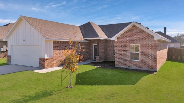 view of front of house featuring a front lawn and a garage