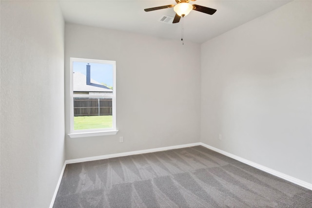 carpeted spare room with ceiling fan