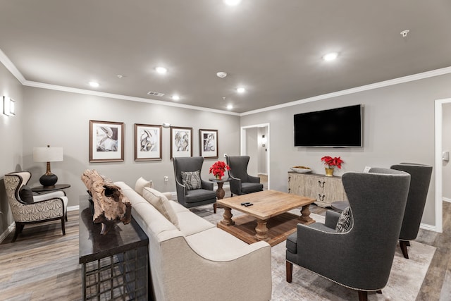 living room featuring crown molding and light hardwood / wood-style floors