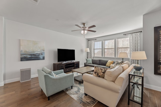 living room with ceiling fan and dark hardwood / wood-style flooring