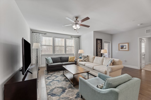 living room with wood-type flooring and ceiling fan