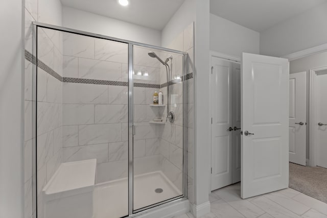 bathroom featuring a shower with door