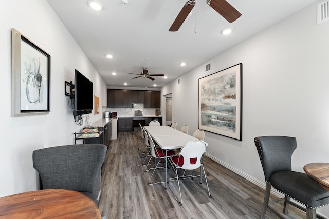 dining room featuring wood-type flooring and ceiling fan