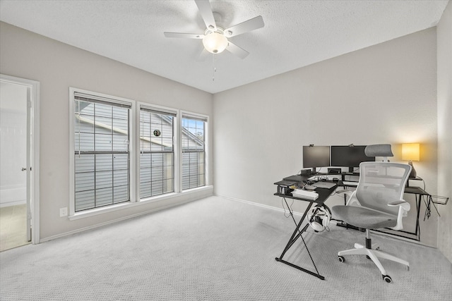 home office with ceiling fan, light colored carpet, and a textured ceiling