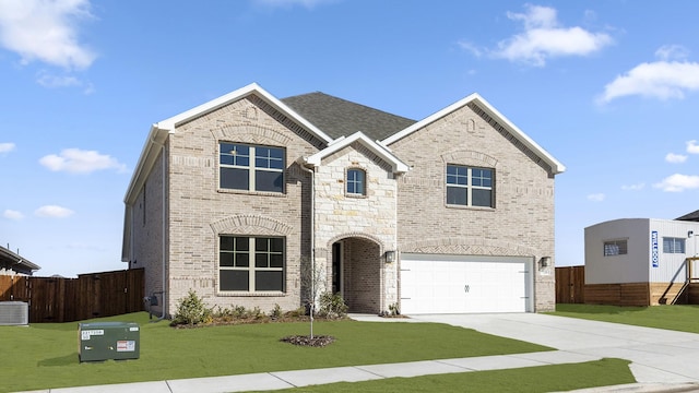 view of front of home with driveway, brick siding, a front lawn, and fence