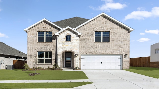 french country inspired facade featuring brick siding, concrete driveway, an attached garage, fence, and a front lawn