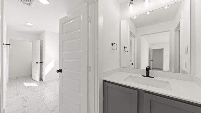 bathroom with marble finish floor, vanity, and visible vents