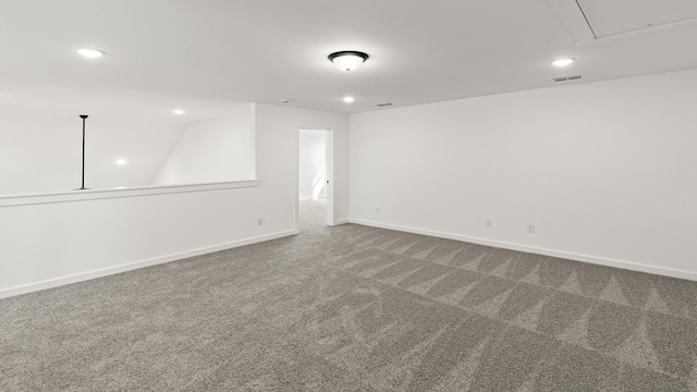 spare room featuring attic access, visible vents, baseboards, carpet, and recessed lighting