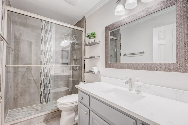 bathroom with crown molding, a shower with door, vanity, and toilet