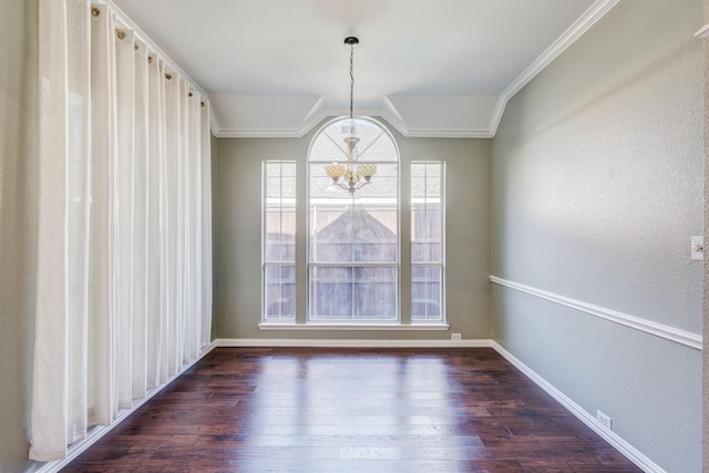 unfurnished dining area featuring a notable chandelier, ornamental molding, and dark wood-type flooring