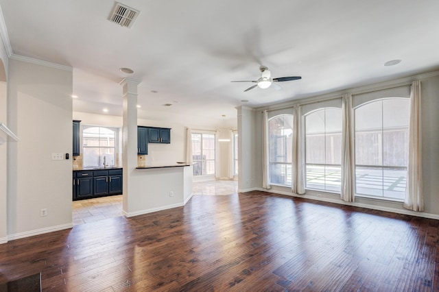 unfurnished living room featuring dark hardwood / wood-style flooring, plenty of natural light, and ceiling fan