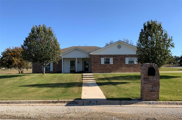 ranch-style home with a front lawn