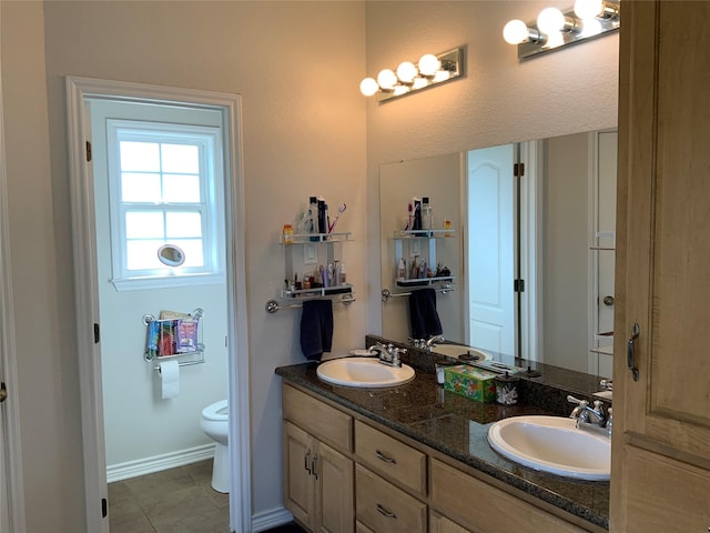 bathroom with vanity, tile patterned flooring, and toilet