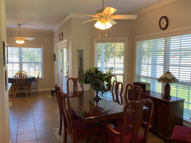 dining room featuring tile patterned flooring, ornamental molding, and ceiling fan