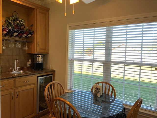 dining space featuring beverage cooler and indoor wet bar