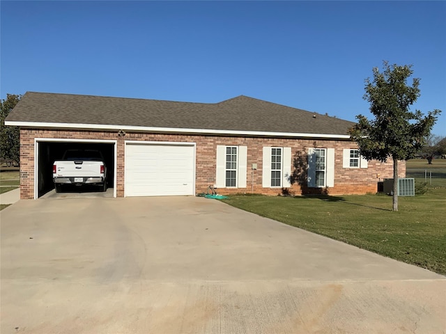 single story home with a garage and a front lawn