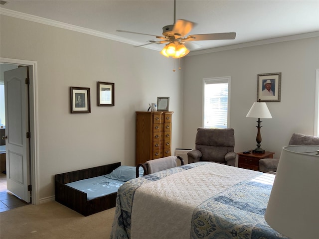 carpeted bedroom featuring crown molding and ceiling fan