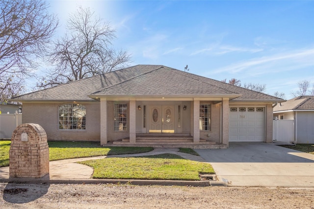 single story home with a front yard and a garage