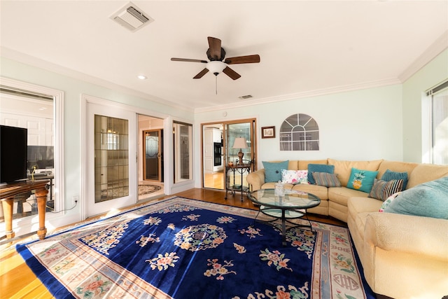 living room featuring crown molding, hardwood / wood-style floors, and ceiling fan