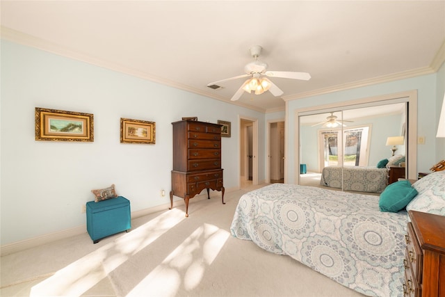 bedroom featuring ceiling fan, carpet floors, ornamental molding, and a closet