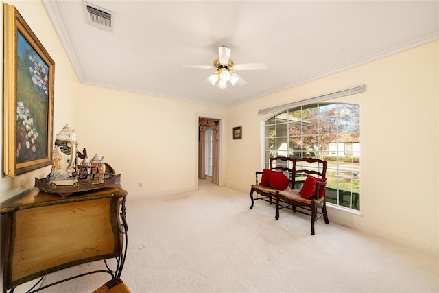 living area with carpet flooring, crown molding, and ceiling fan