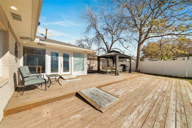 deck featuring a gazebo and french doors