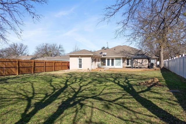 back of property featuring a patio area and a yard