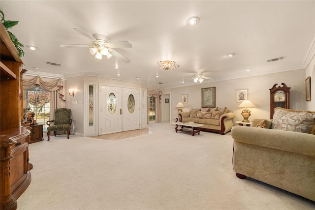 carpeted living room with ceiling fan and ornamental molding