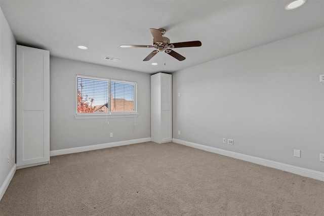 unfurnished bedroom with ceiling fan and light colored carpet