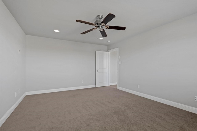 spare room with carpet floors and ceiling fan