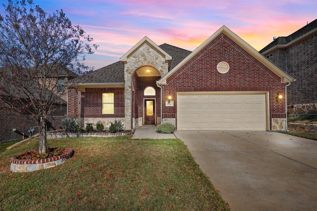 view of front of house with a garage and a yard