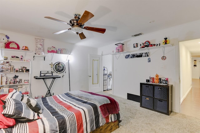 bedroom featuring ceiling fan, ornamental molding, and light carpet