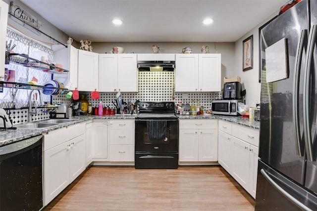 kitchen with black appliances, sink, light hardwood / wood-style flooring, stone countertops, and white cabinetry