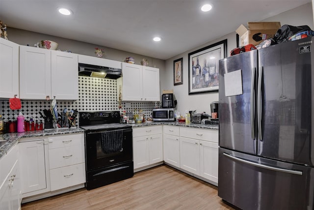 kitchen with light hardwood / wood-style floors, light stone counters, white cabinetry, and stainless steel appliances