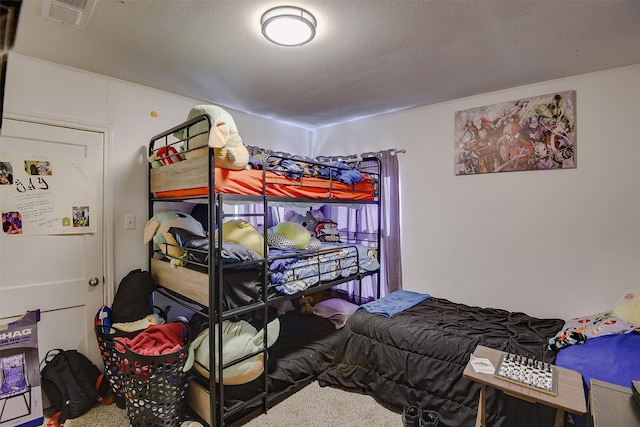 carpeted bedroom featuring a textured ceiling